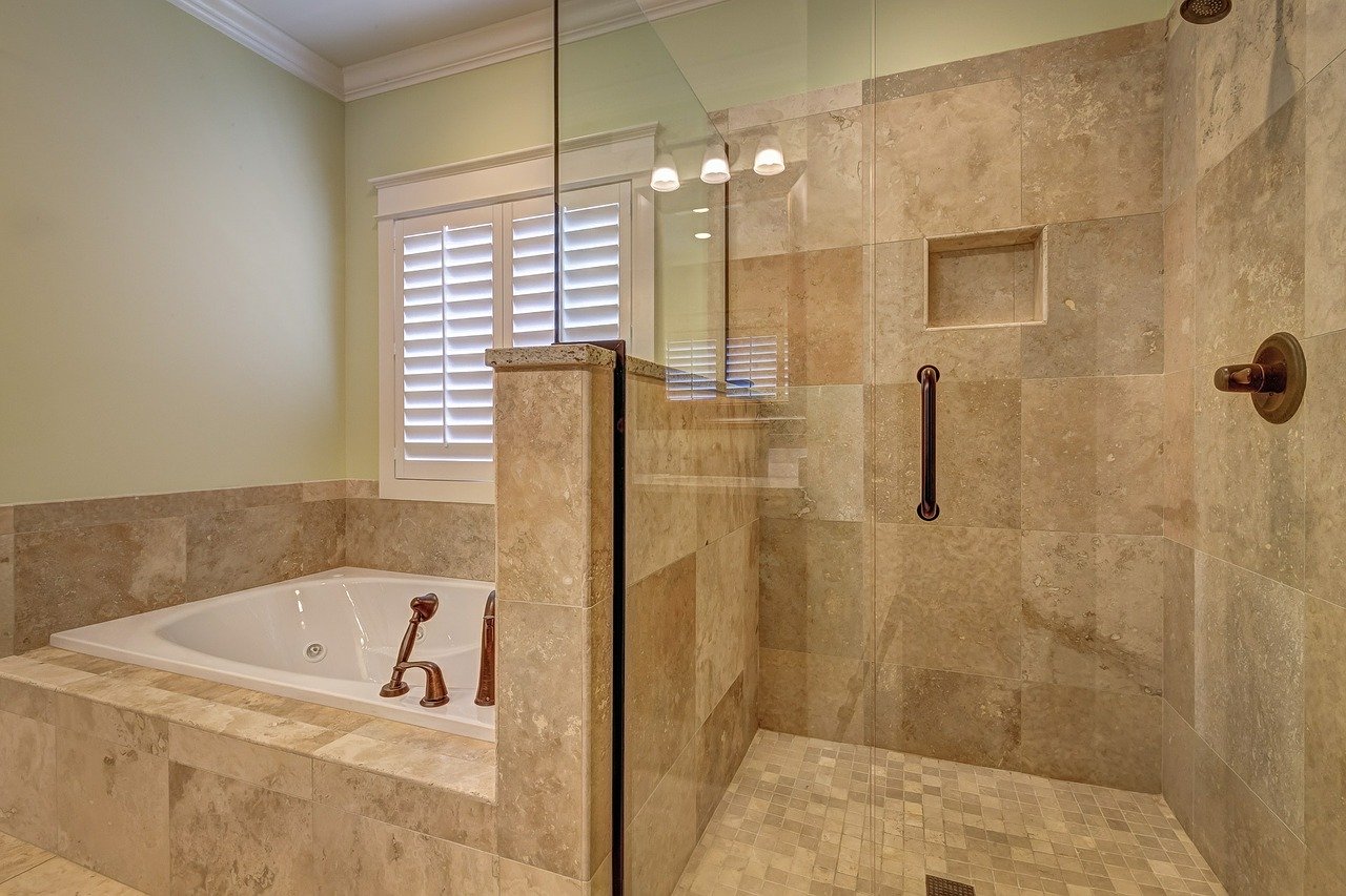 Luxury bathroom bathtub and shower installed with mosaic tile in Austin,TX